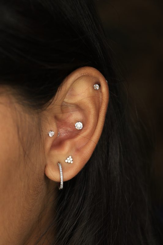 Multiple lobe and cartilage piercings with hoop