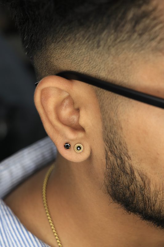Black gem and Greek key stud lobe piercings