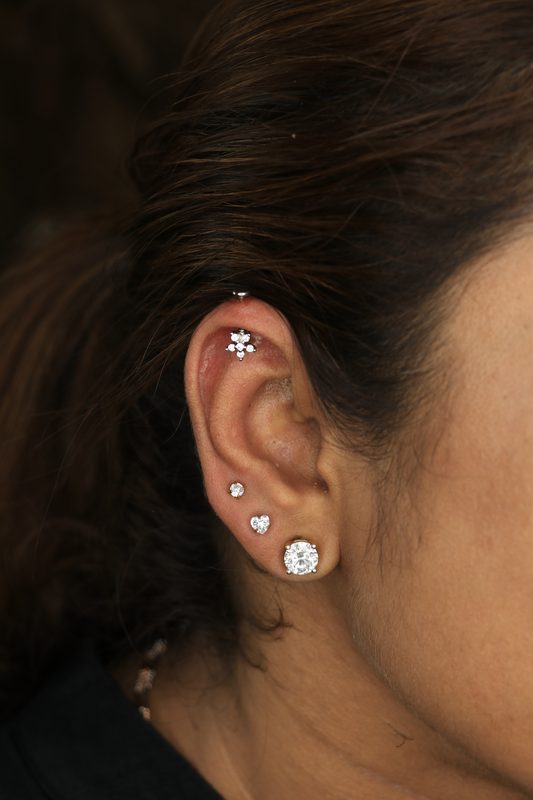 Helix piercing with cross cluster stud