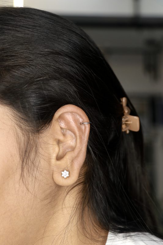 Helix hoop piercing with pave cuff