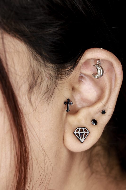 Tragus piercing with black gem stud