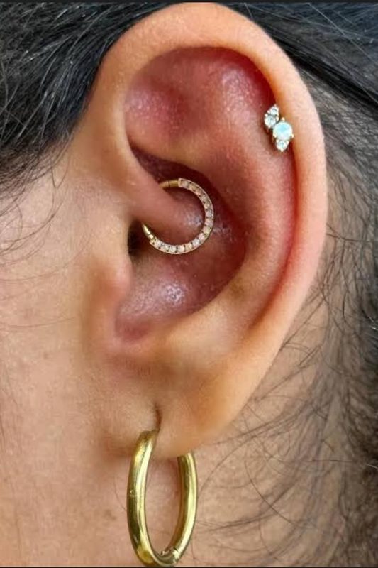 Daith piercing with gold pave crescent hoop
