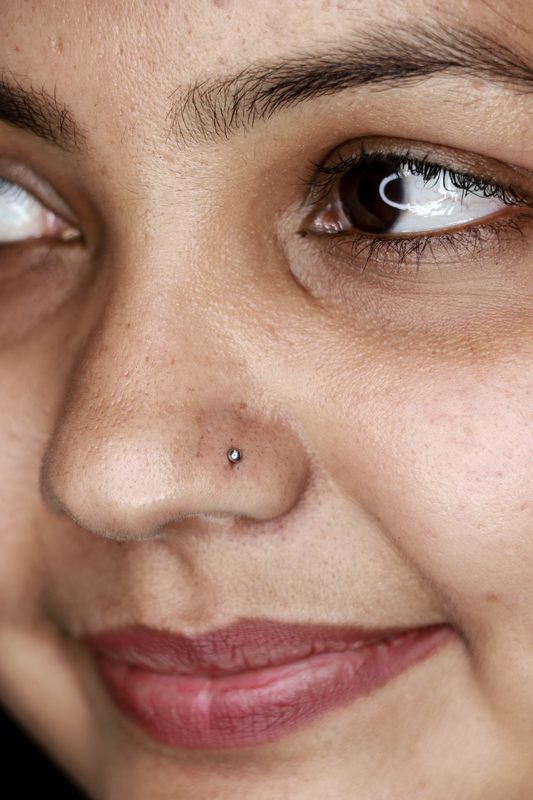 Nostril piercing with silver ball stud closeup