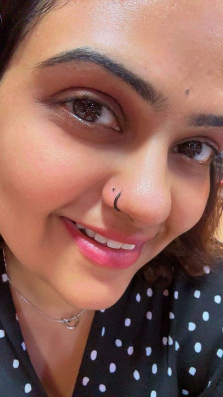 Nostril piercing with black hoop ring