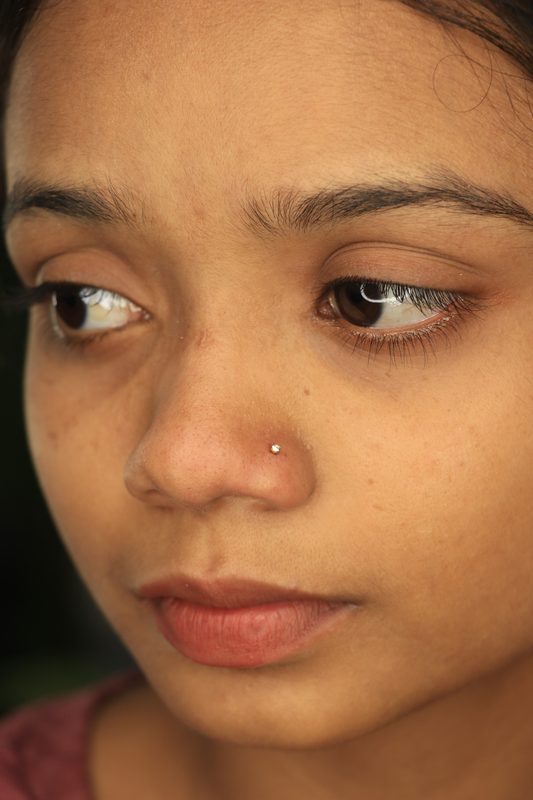 Nostril piercing with gold stud