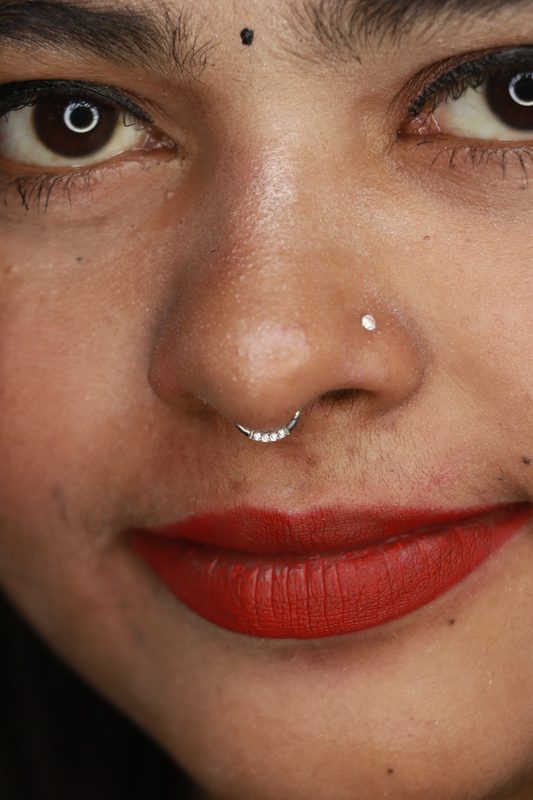 Septum piercing with silver pave clicker ring