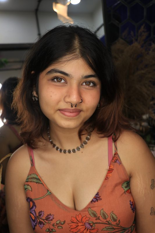 Septum piercing with black beaded ring
