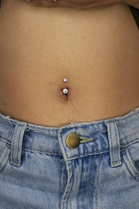 Navel piercing with double crystal curved barbell
