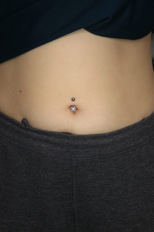 Navel piercing with prong set crystal drop