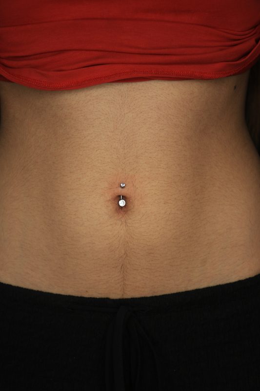 Navel piercing with double crystal barbell