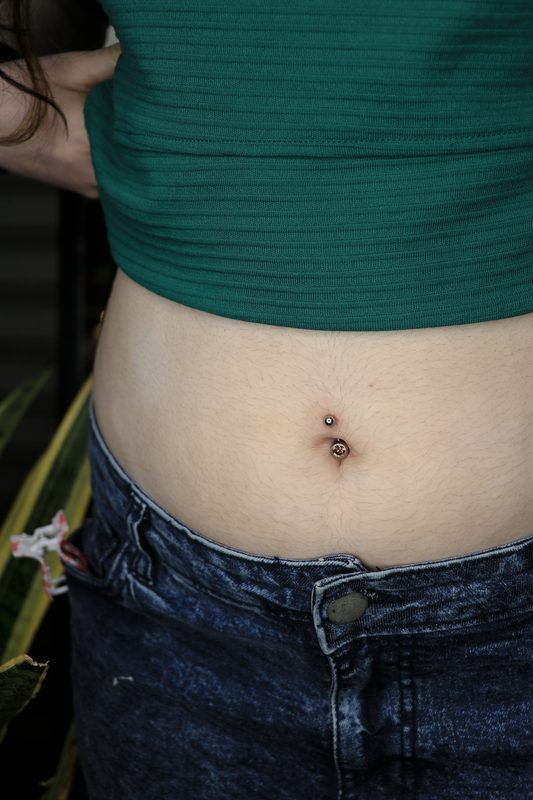 Rose gold navel piercing with gem