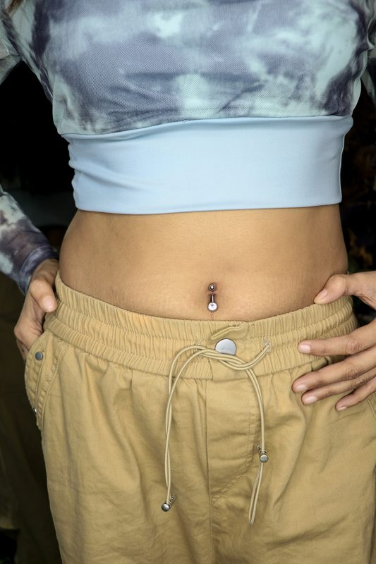 Navel piercing with crystal drop barbell