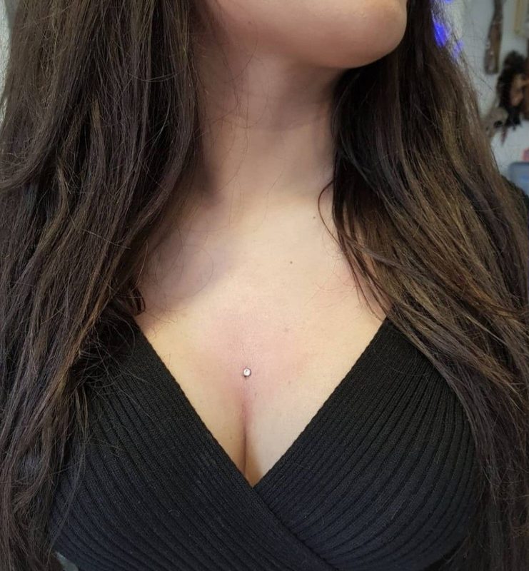 Cleavage microdermal piercing with crystal
