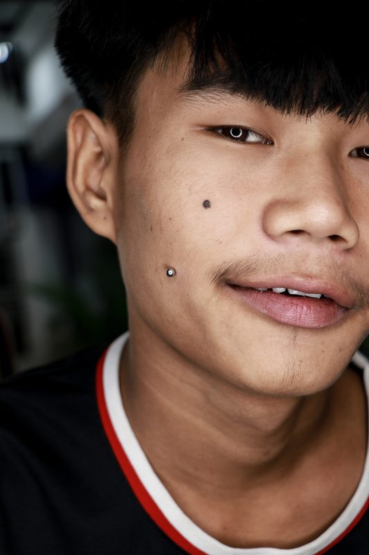 Dimple cheek piercing with steel ball stud