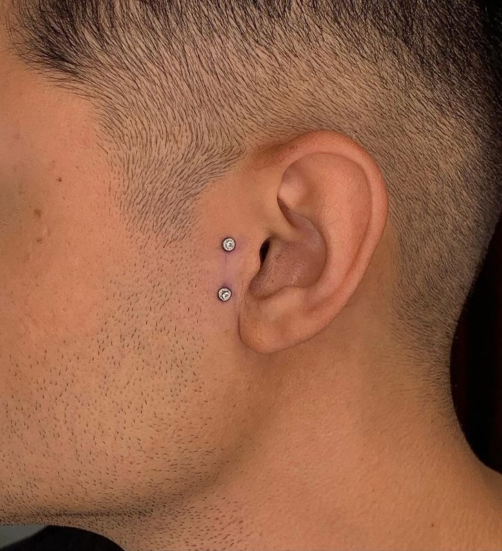 Surface tragus piercing with two crystal studs