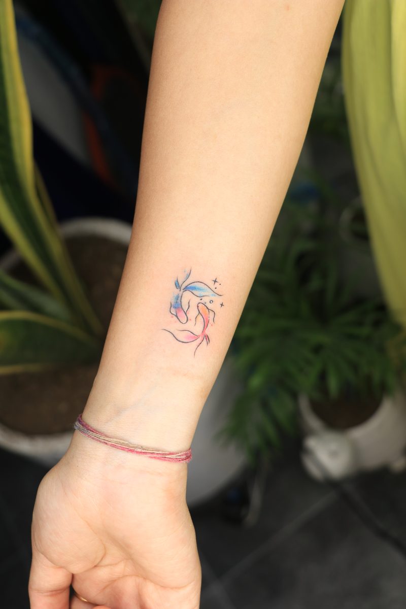 Watercolor koi fish pair wrist tattoo