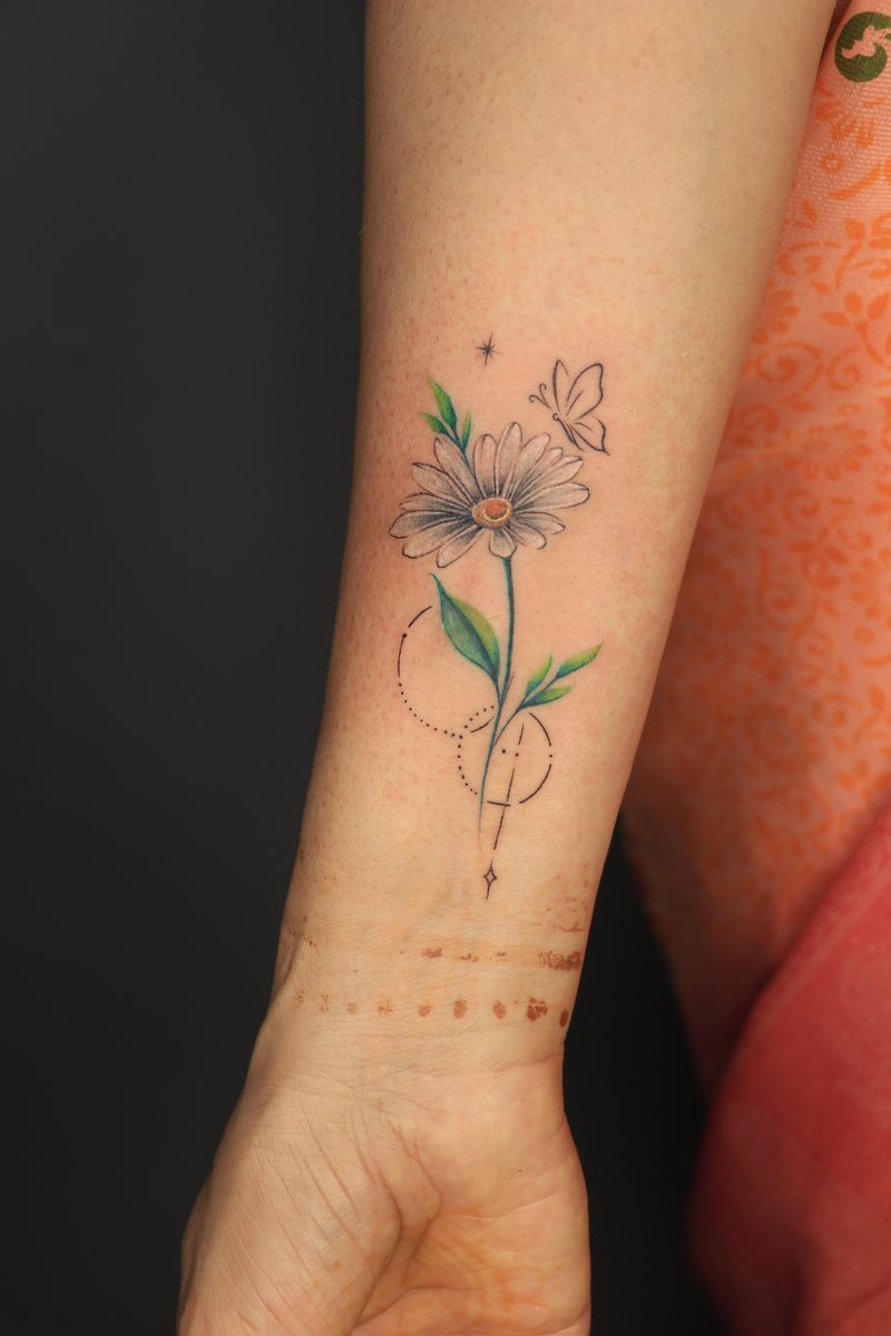 Daisy flower with butterfly color tattoo