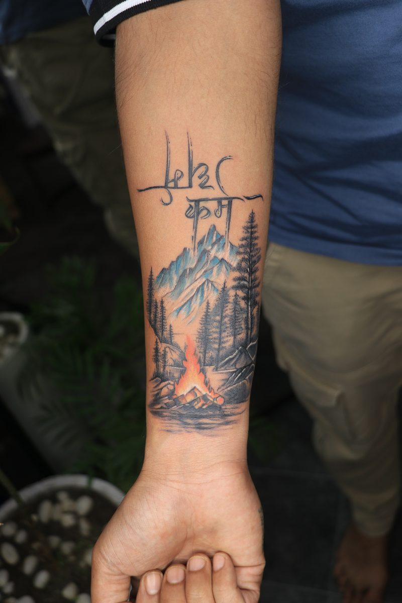 Mountains campfire with karma hindi color tattoo