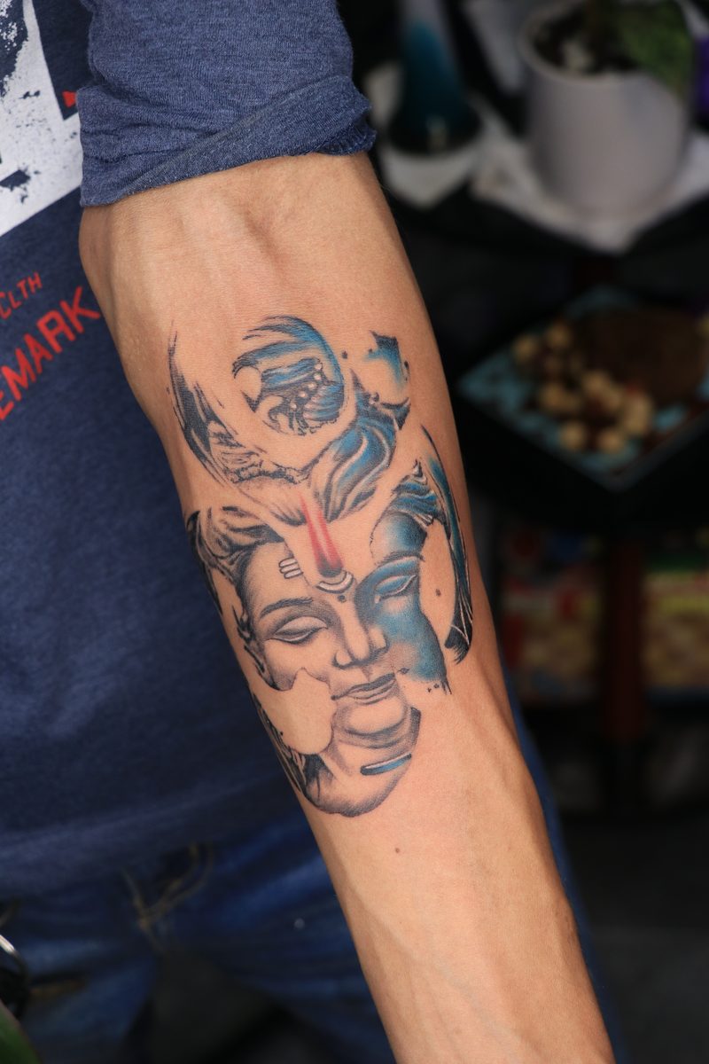 Shiva Parvati blue color tattoo with trishul