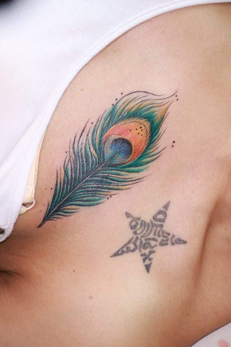 Peacock feather chest color tattoo