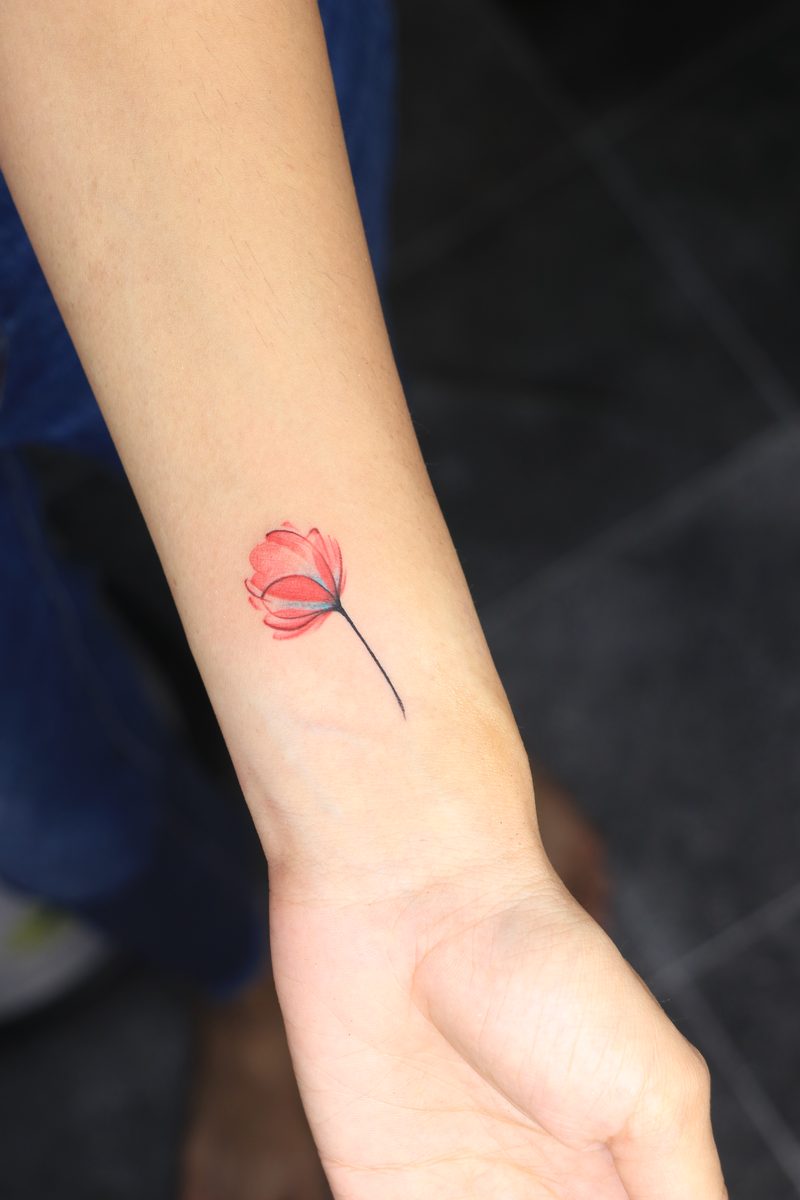 Red poppy watercolor wrist tattoo
