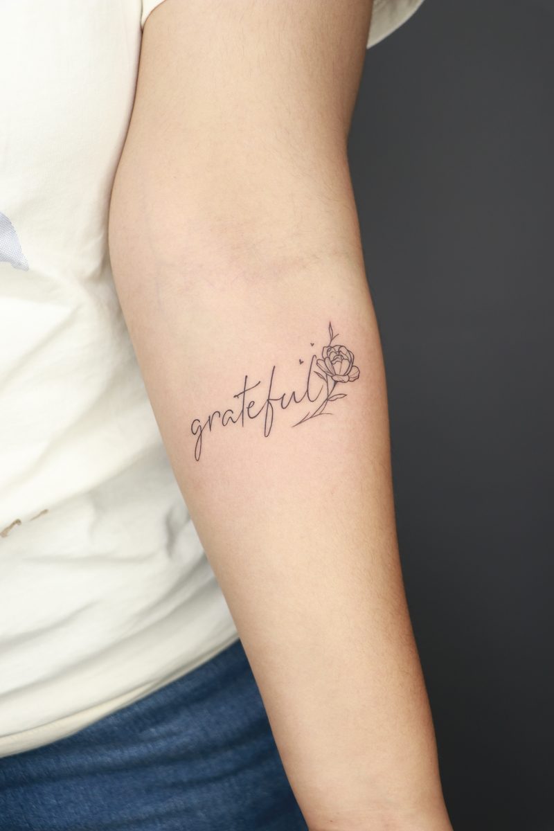 Grateful script with rose fine line tattoo
