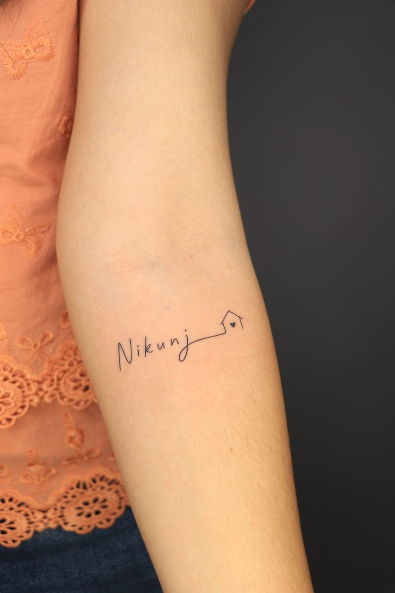 Nikunj name tattoo with home symbol