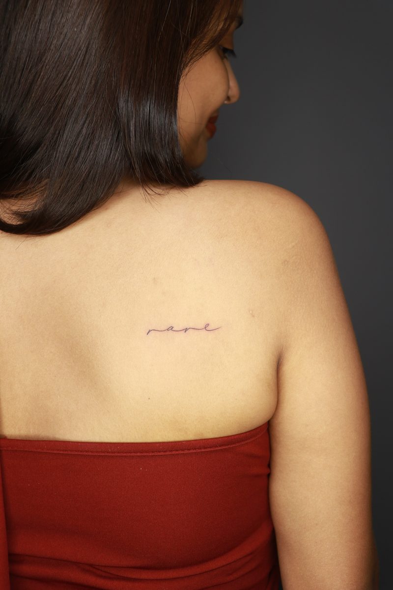 Rare minimal script tattoo on back