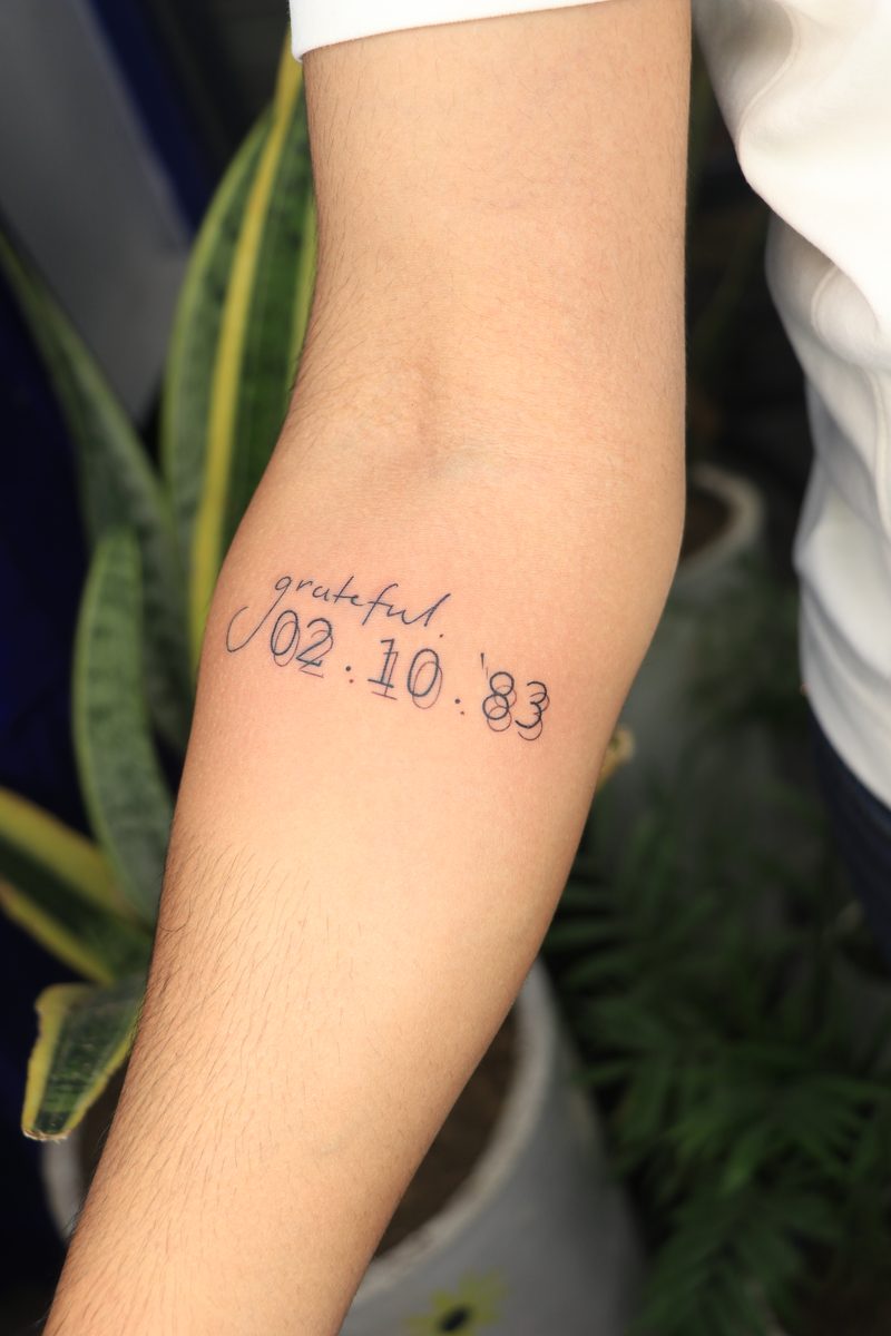 Grateful script with date fine line tattoo