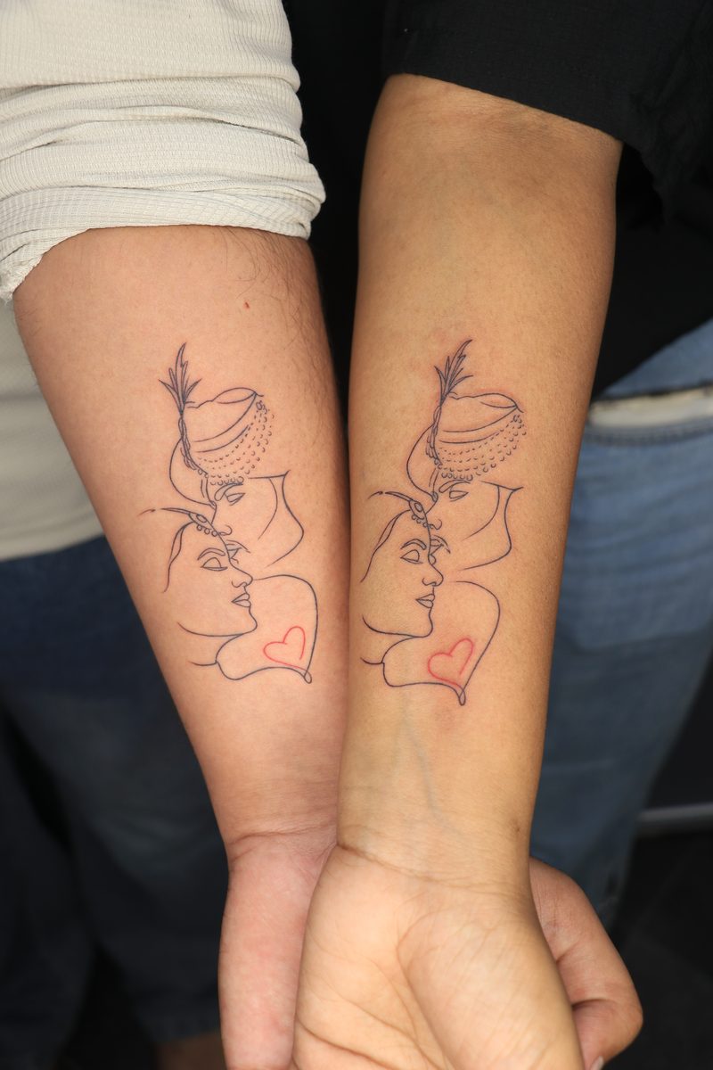 Matching couple faces line art tattoos