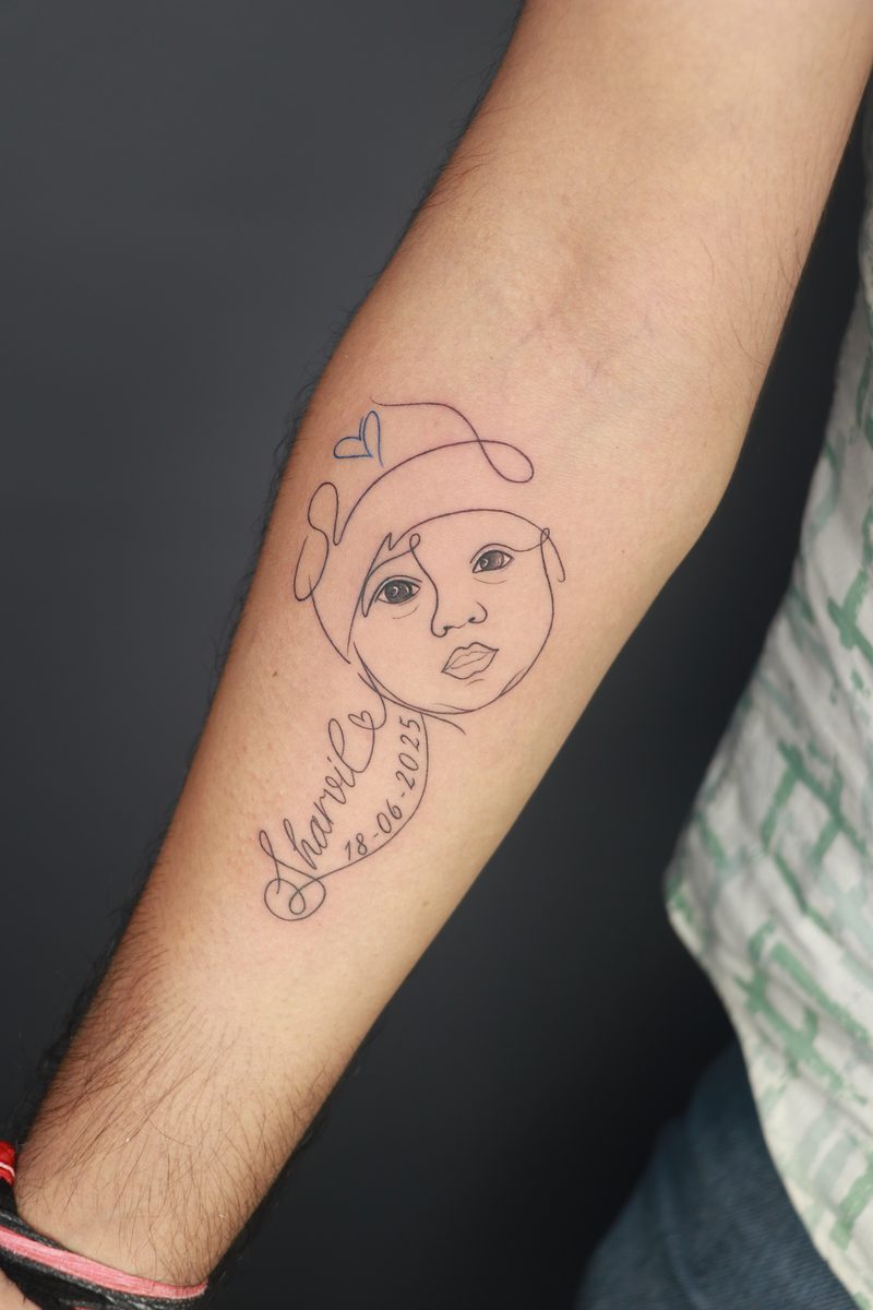 Baby portrait line art tattoo with name and date