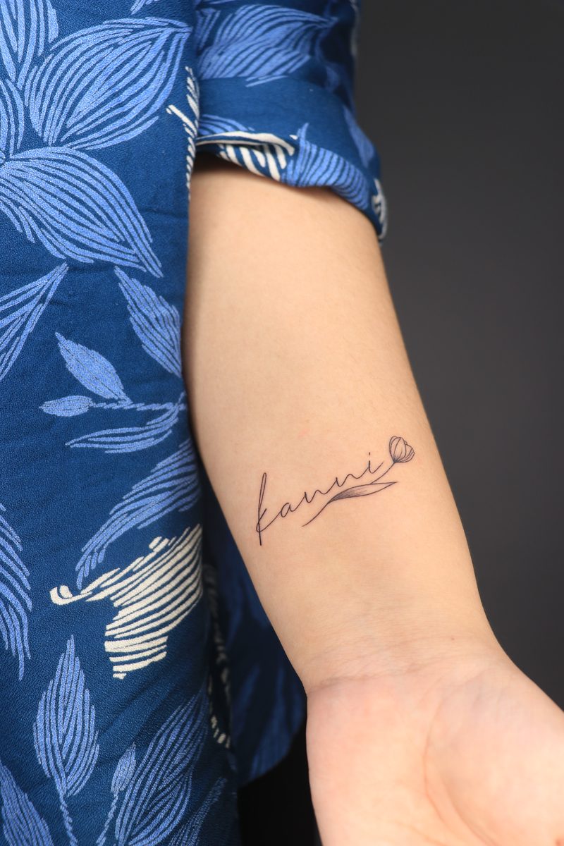 Name script with tulip fine line tattoo