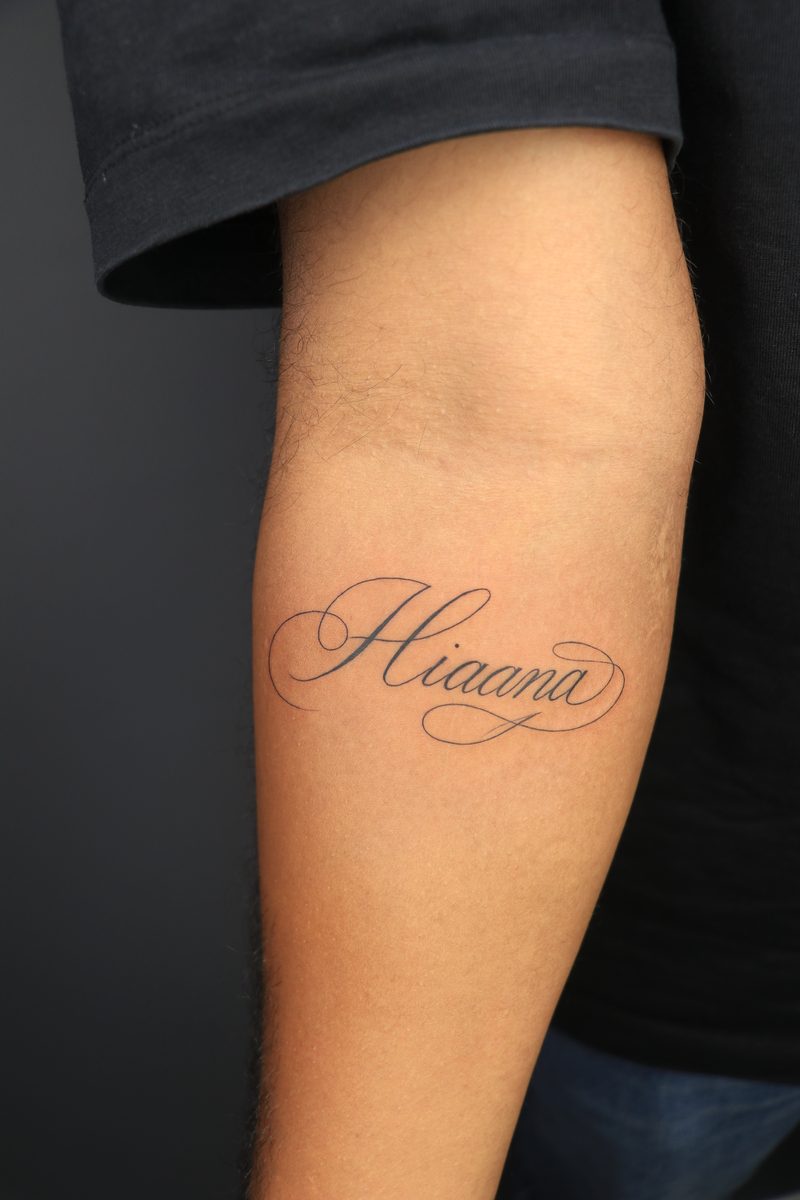 Hiaana name calligraphy fine line tattoo