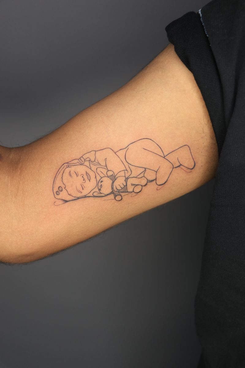 Sleeping baby line art tattoo
