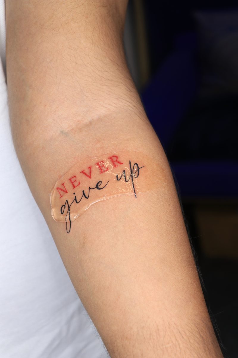 Never give up script tattoo