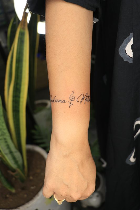 Hakuna Matata script armband tattoo on wrist