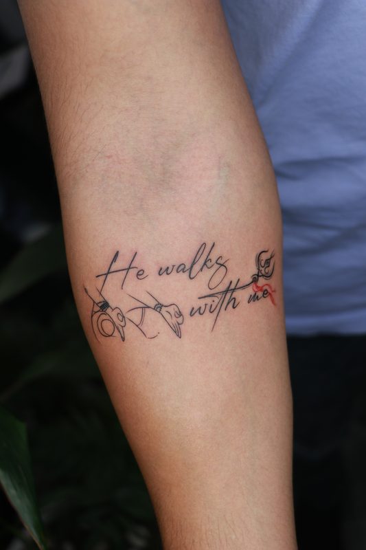He walks with me script tattoo with Krishna flute and hands