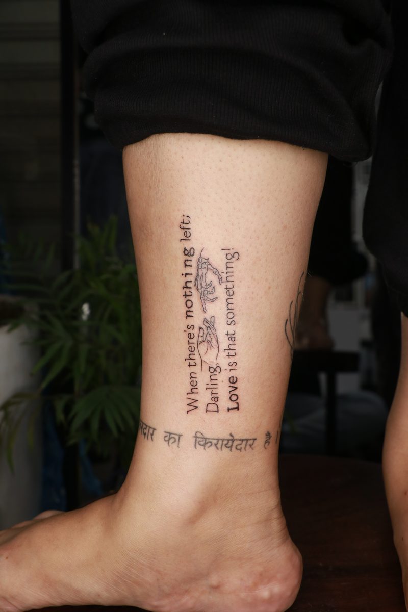 Love quote with hands ankle script tattoo