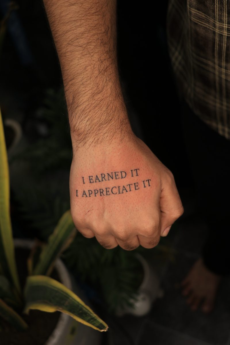 I earned it I appreciate it hand script tattoo